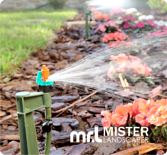 A picture of a micro sprayer in a garden watering plants.