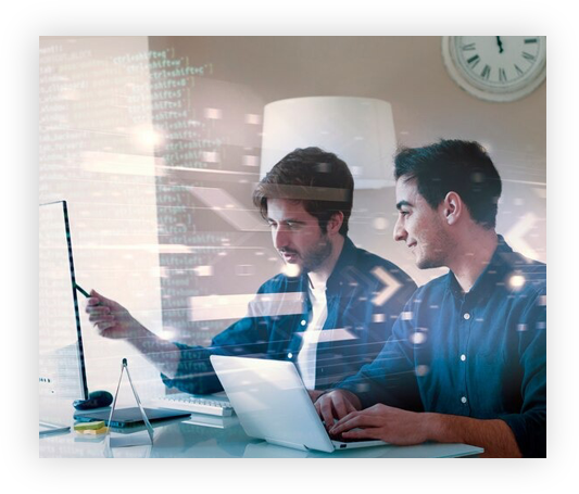 Two men working on laptops discussing a project with holographic text displayed over the image.